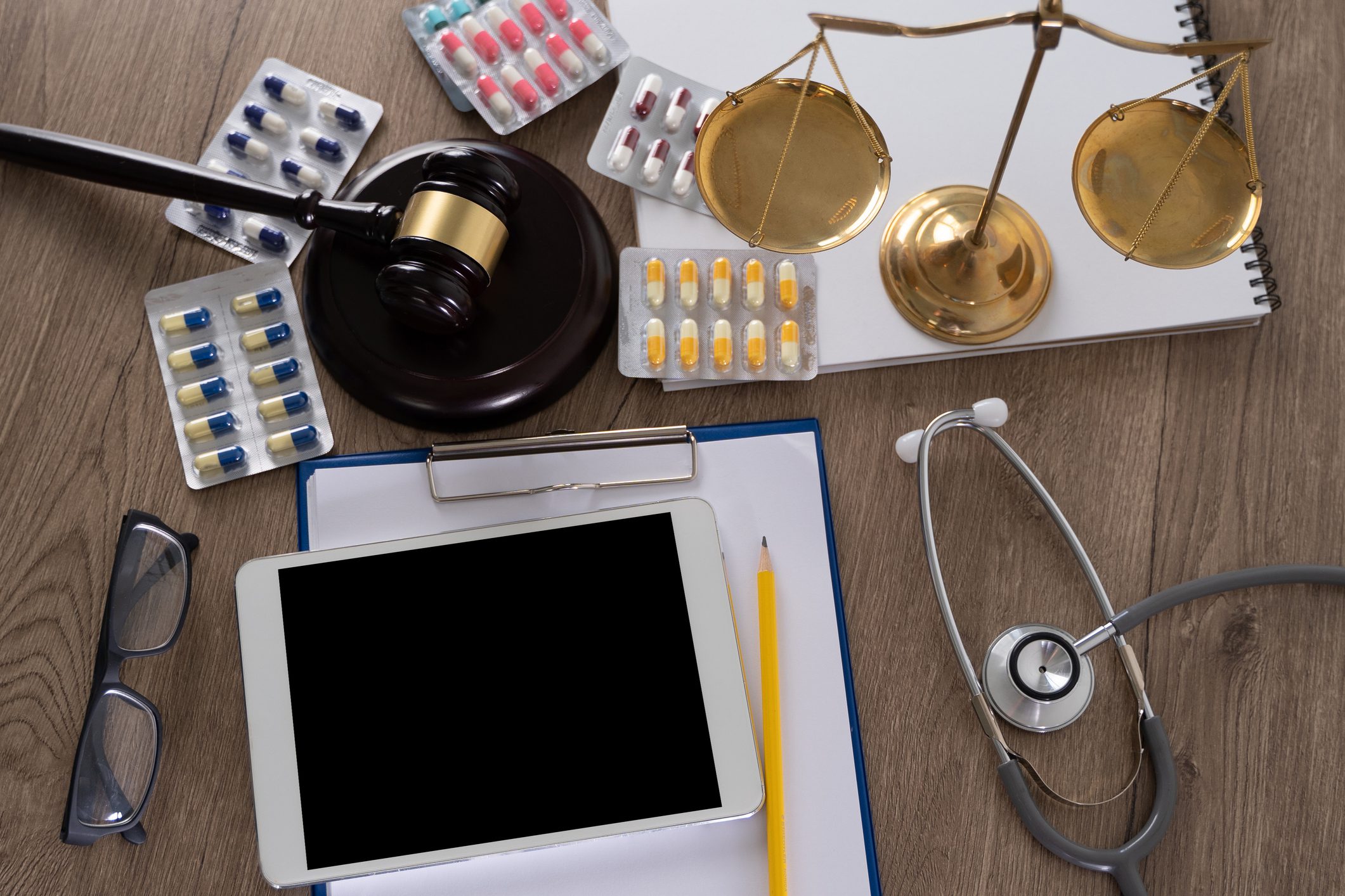 Tablet, scales, and medication on desk