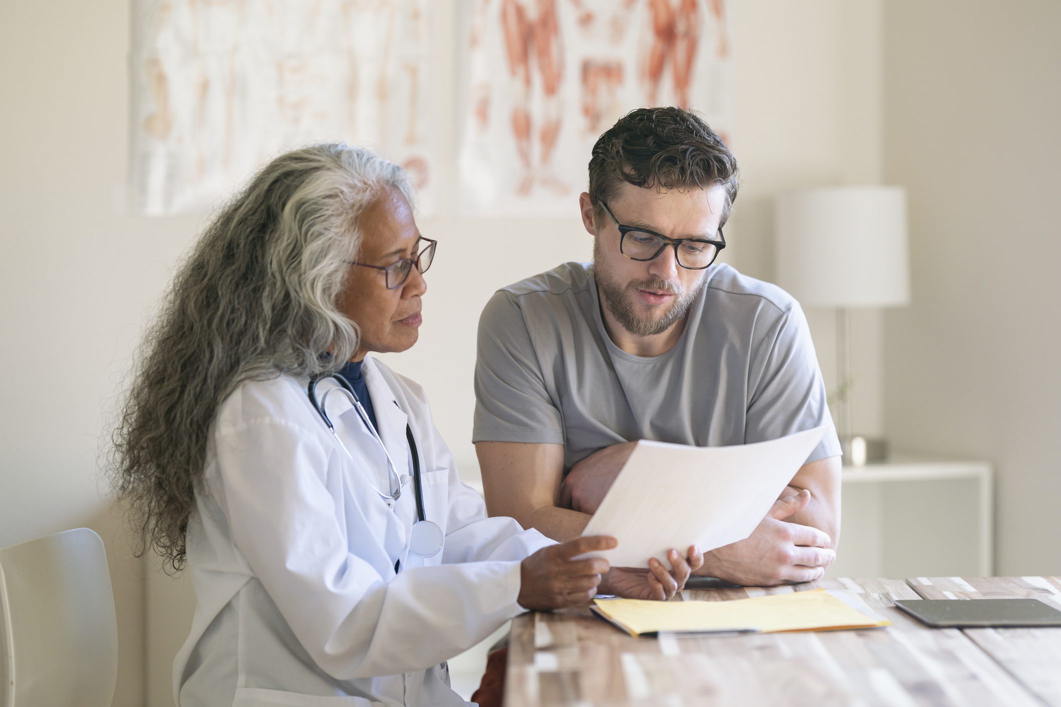 Doctor discussing paperwork with a patient