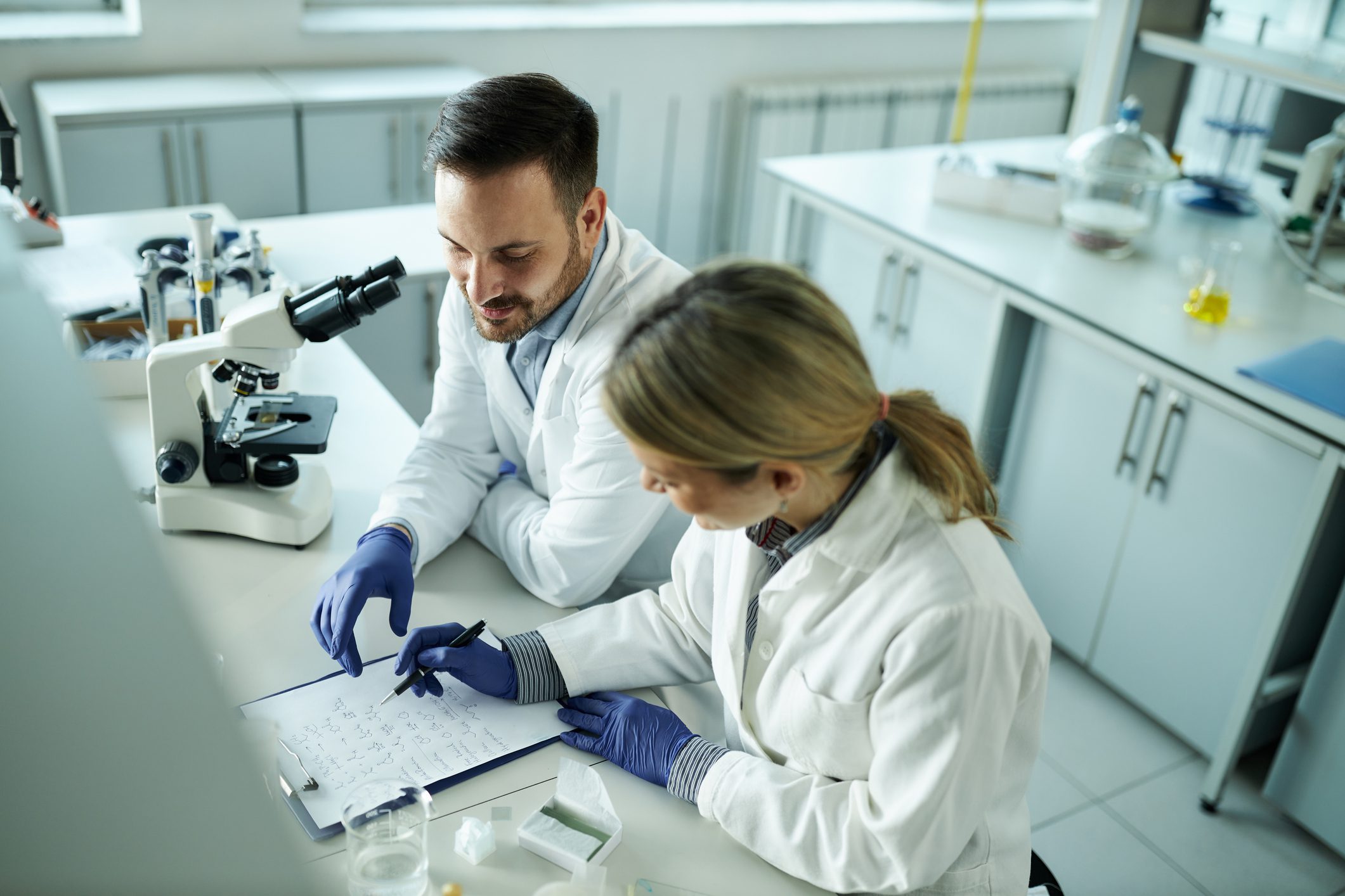 Scientists discussing research in laboratory