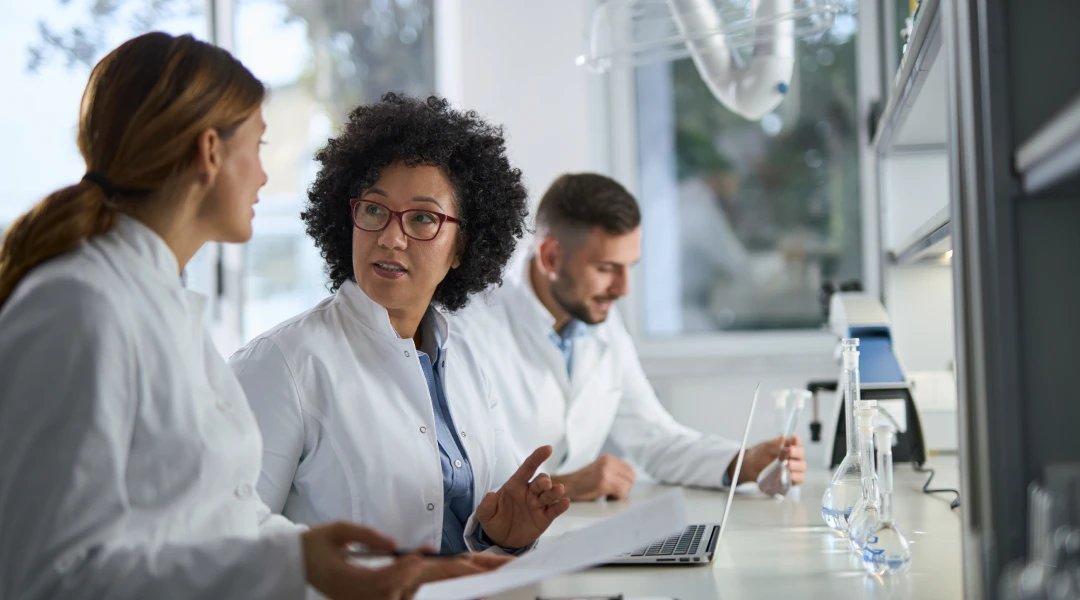 Scientists discussing research in laboratory