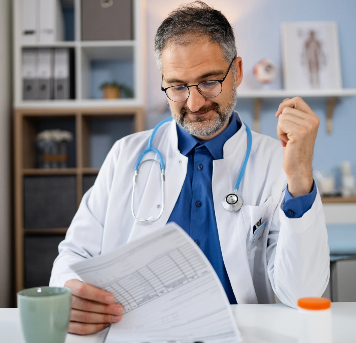 Doctor reviewing medical documents at desk